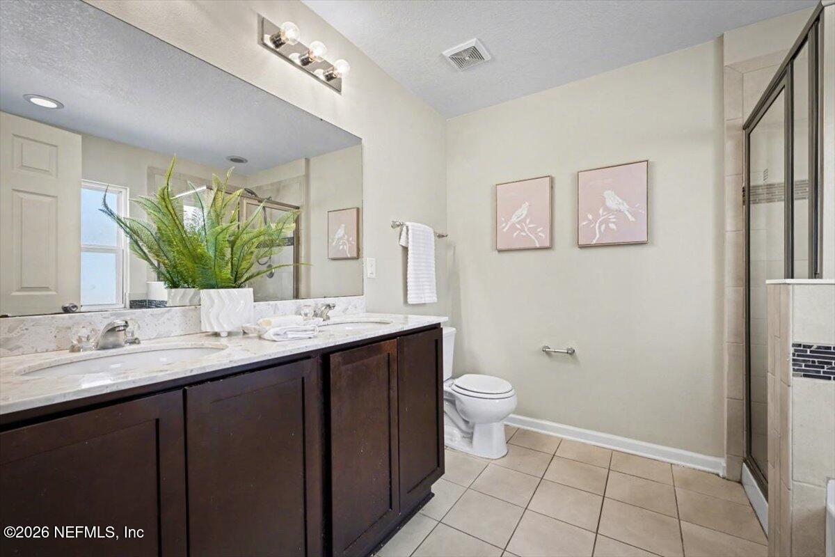 7401 Steventon Way Jacksonville, FL 32244 - Photo 16 of 32 a bathroom with a granite countertop sink toilet and mirror