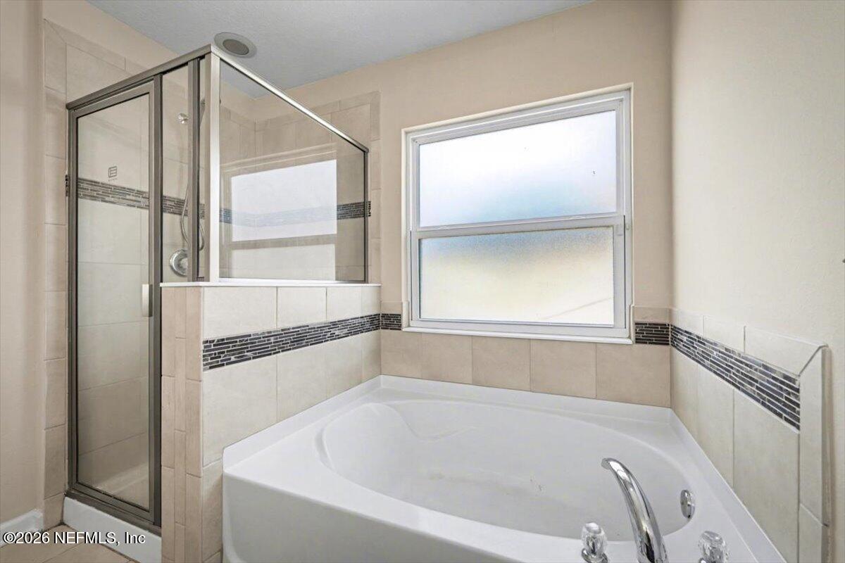 7401 Steventon Way Jacksonville, FL 32244 - Photo 17 of 32 a bathroom with a bathtub and a shower