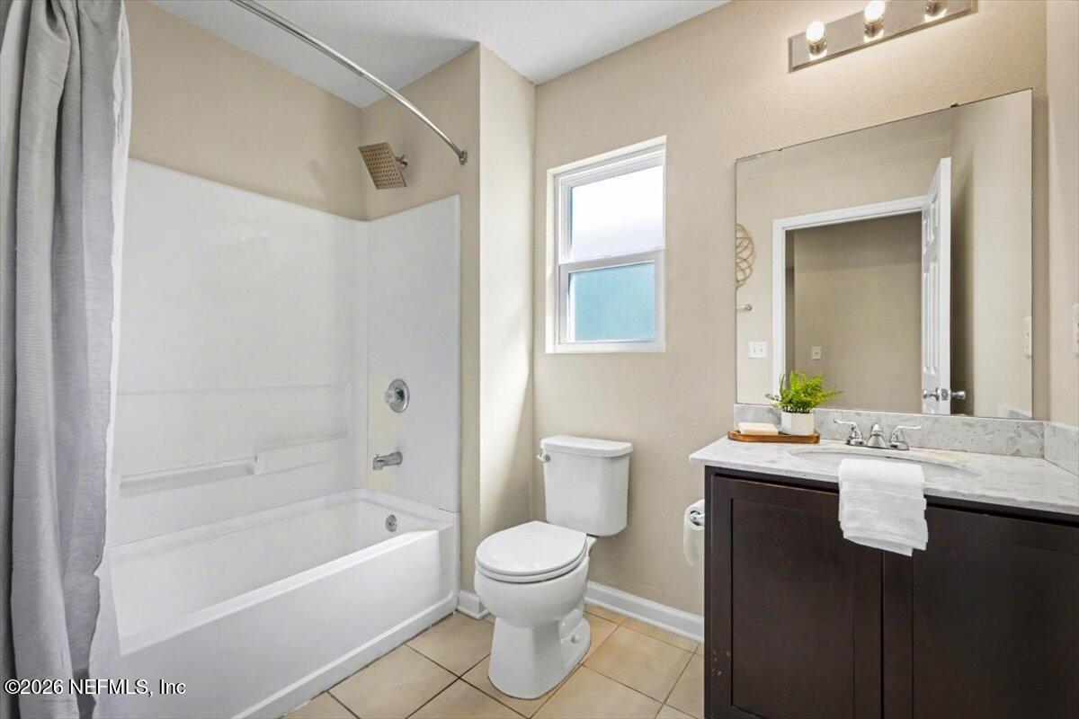 7401 Steventon Way Jacksonville, FL 32244 - Photo 20 of 32 a bathroom with a granite countertop sink a toilet and shower