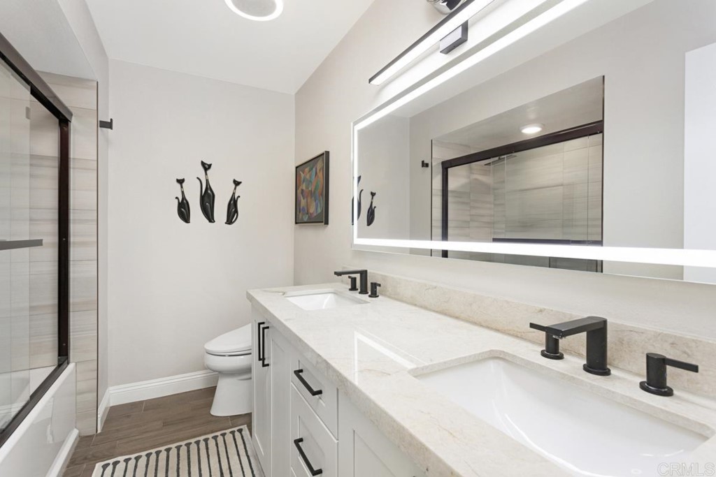 620 West Solana Circle, Unit 3A Solana Beach, CA 92075 - Photo 12 of 37 a bathroom with a sink a toilet and a mirror