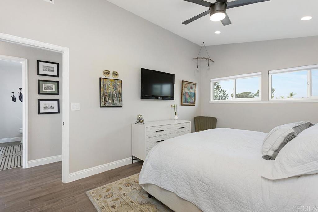 620 West Solana Circle, Unit 3A Solana Beach, CA 92075 - Photo 18 of 37 a bedroom with a bed and a flat screen tv
