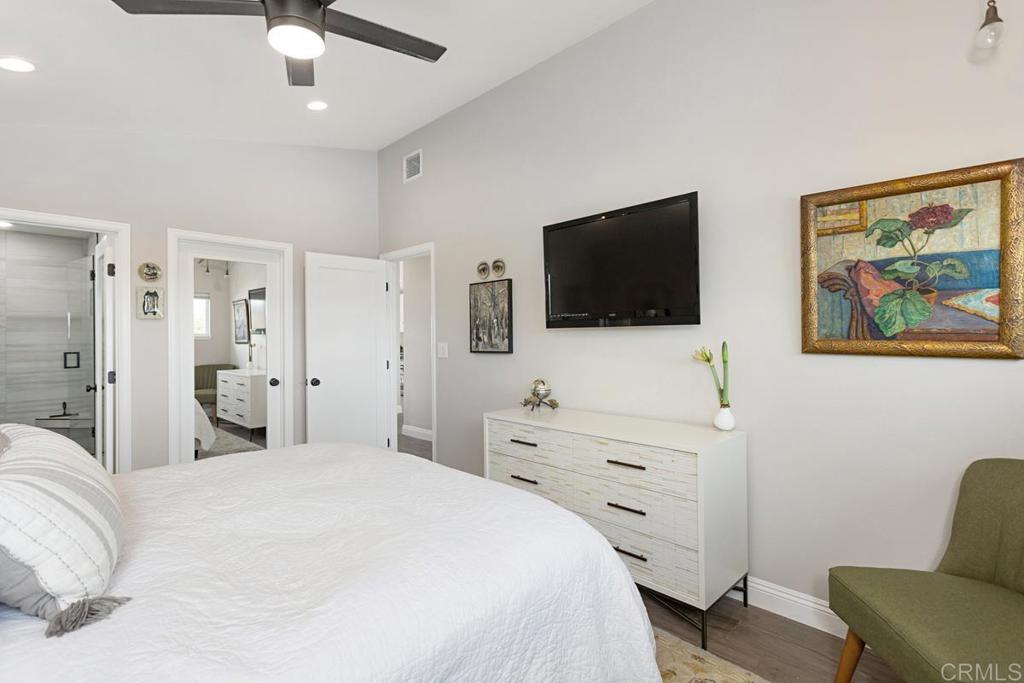 620 West Solana Circle, Unit 3A Solana Beach, CA 92075 - Photo 19 of 37 a bedroom with a bed and a flat screen tv