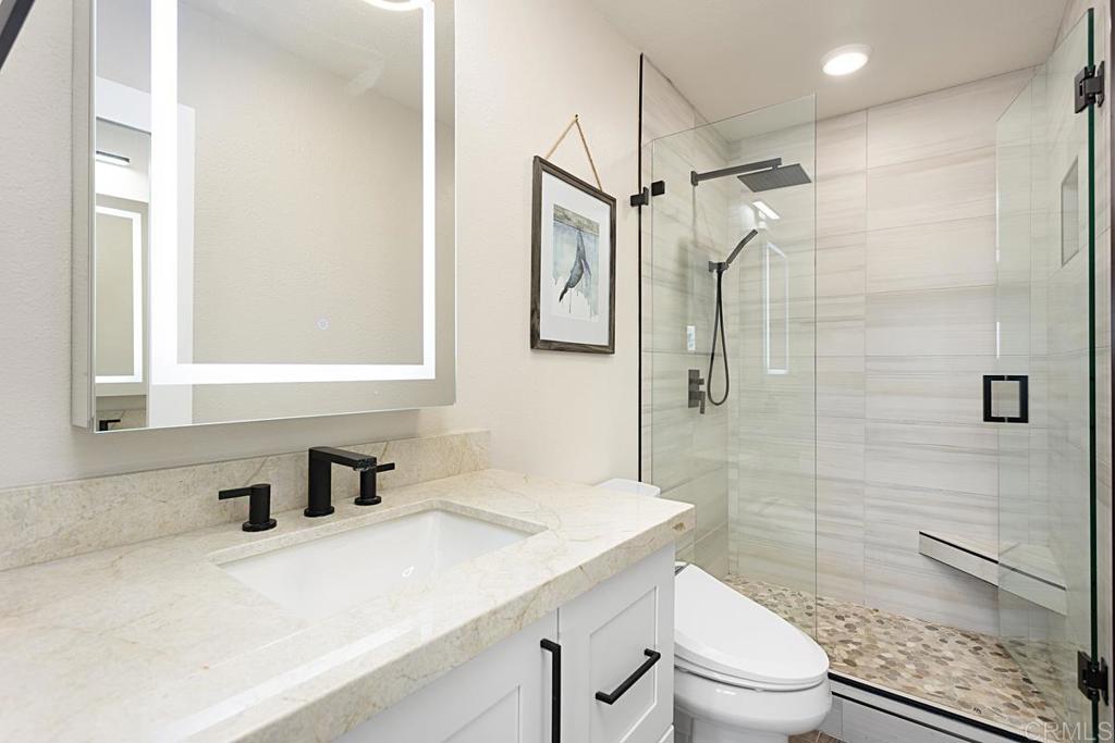 620 West Solana Circle, Unit 3A Solana Beach, CA 92075 - Photo 20 of 37 a bathroom with a sink a toilet and shower