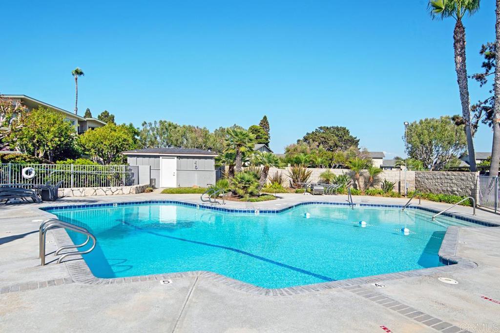 620 West Solana Circle, Unit 3A Solana Beach, CA 92075 - Photo 30 of 37 a view of a swimming pool with a lawn chairs potted plants and large tree