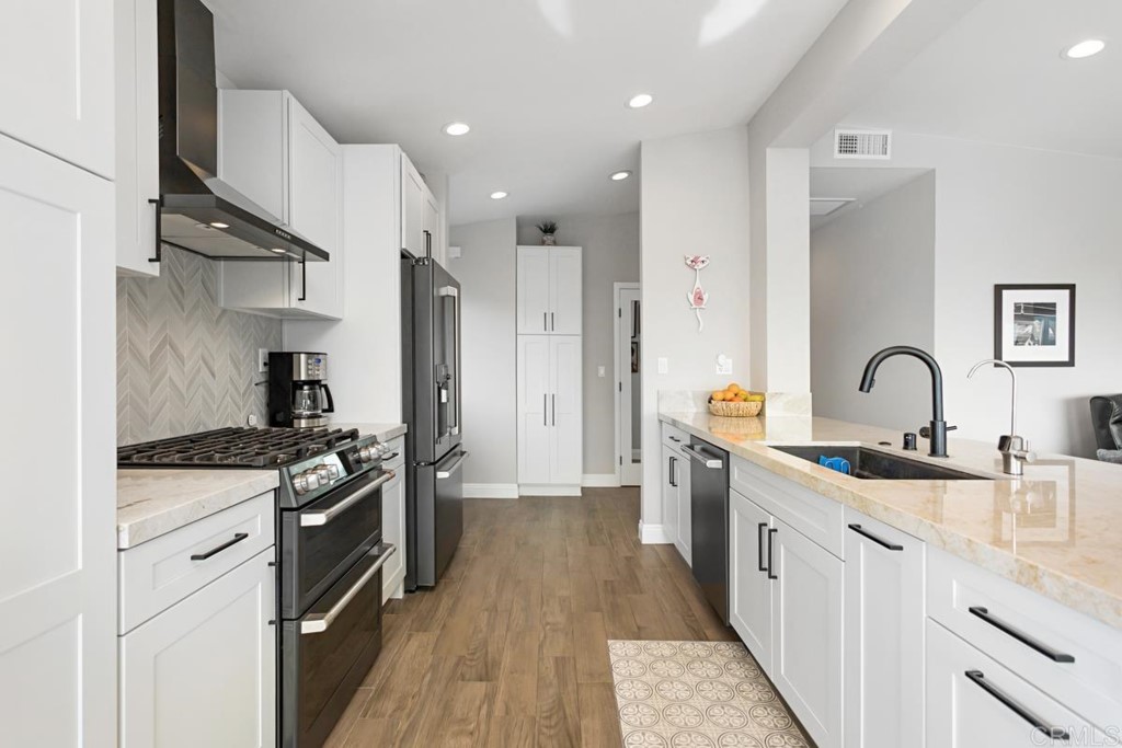 620 West Solana Circle, Unit 3A Solana Beach, CA 92075 - Photo 3 of 37 a kitchen with stainless steel appliances granite countertop a sink stove and cabinets