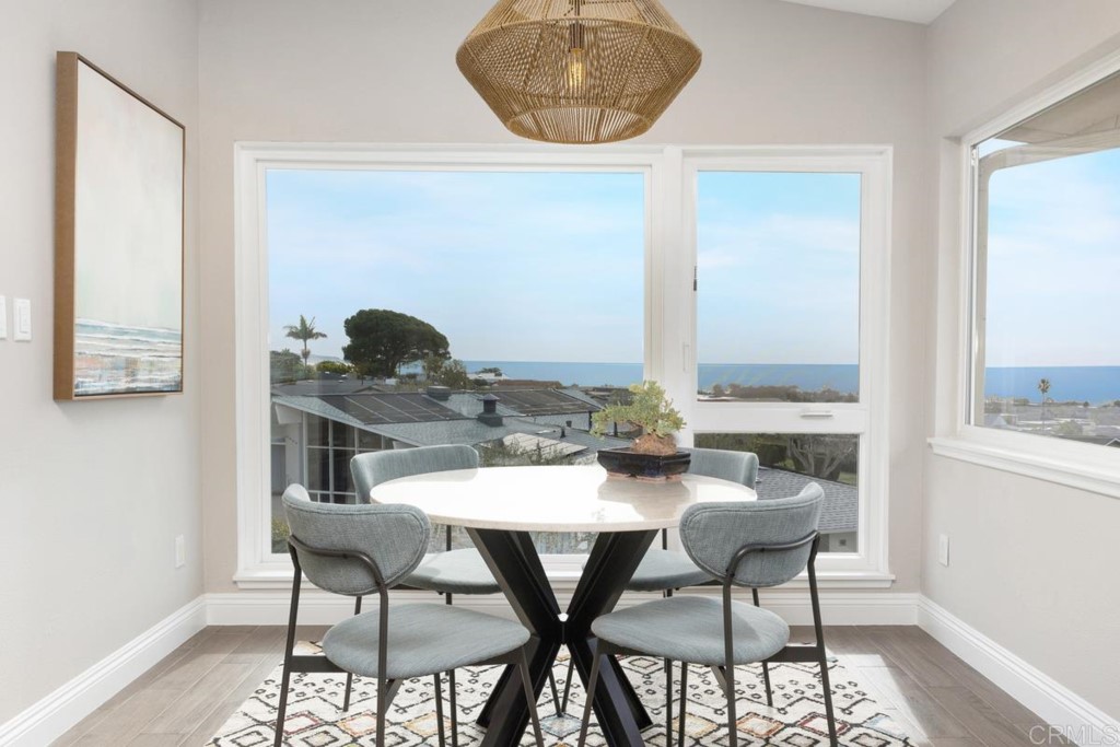 620 West Solana Circle, Unit 3A Solana Beach, CA 92075 - Photo 7 of 37 a view of a dining room with furniture and wooden floor