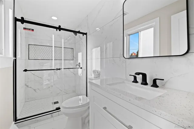 a bathroom with a sink toilet and shower