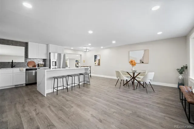 a view of a kitchen with dining room and wooden floor