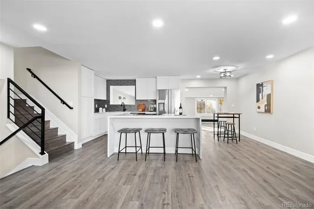 a dining room with furniture and wooden floor