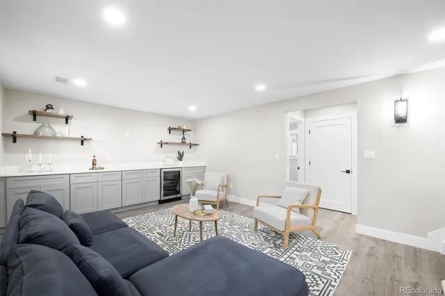 a living room with furniture a rug and white walls