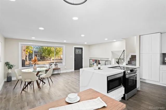 a large white kitchen with a table and chairs