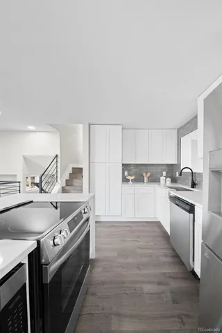 a kitchen with a stove top oven sink and cabinets