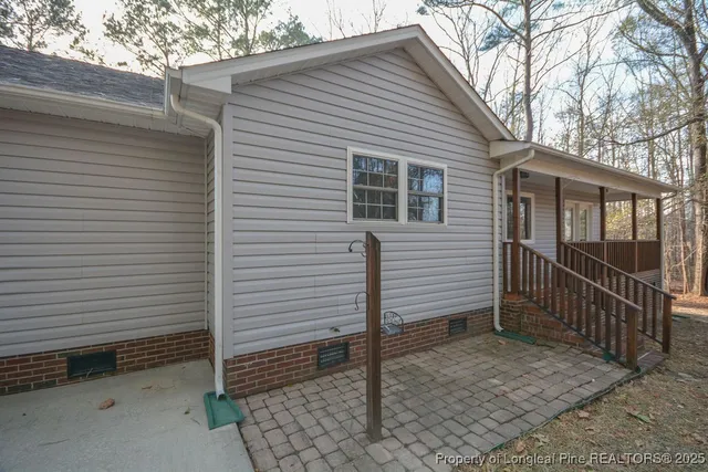 a view of a house with a small yard and a large window