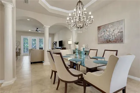 a view of a dining room with furniture and chandelier