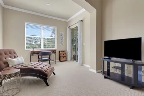 a bedroom with furniture and a flat screen tv