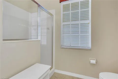 a bathroom with a toilet and a shower curtain