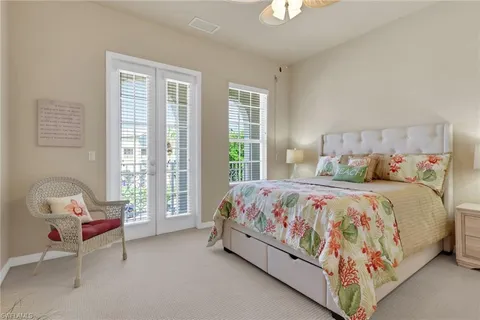 a bedroom with a bed chair and window