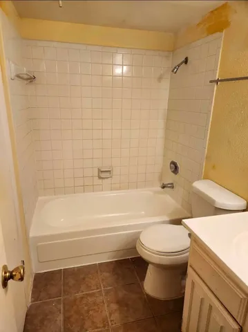 a bathroom with a toilet and a bath tub