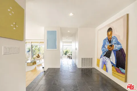 a view of a hallway with furniture and a living room