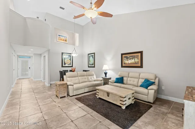 a living room with furniture and a large window with garden view