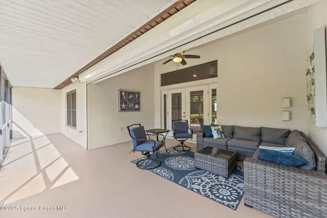 a spacious bedroom with a bed a couch and a flat screen tv