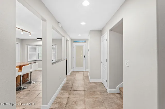 a view of a hallway with closet and bathroom