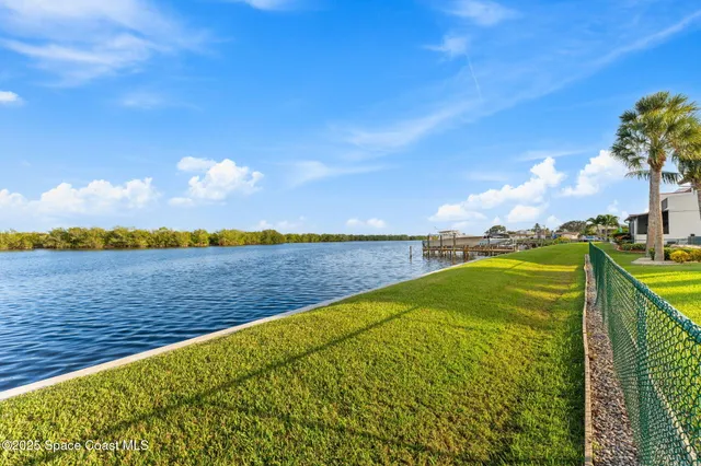 an aerial view of swimming pool with outdoor seating and yard