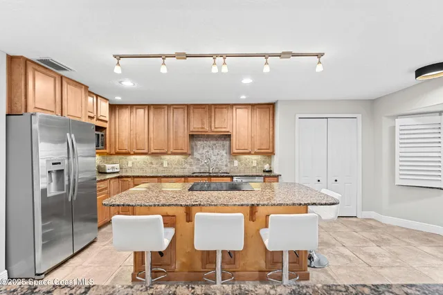 a dining room with a wooden table and chairs