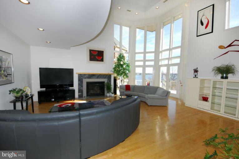 770 South River Landing Road, Unit 770 Edgewater, MD 21037 - Photo 9 of 30 Living room has hardwood floors & gas fireplace