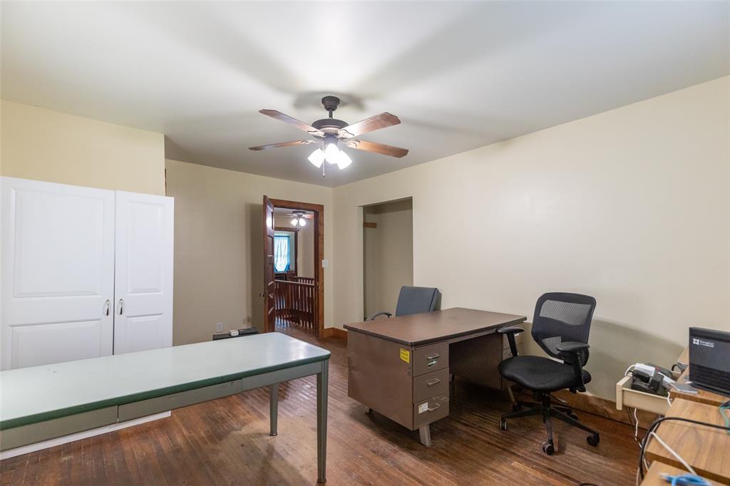 640 Ground Street Moran, TX 76464 - Photo 26 of 35 Spacious room featuring wood-finish flooring, a ceiling fan with integrated lighting, and neutral-toned walls