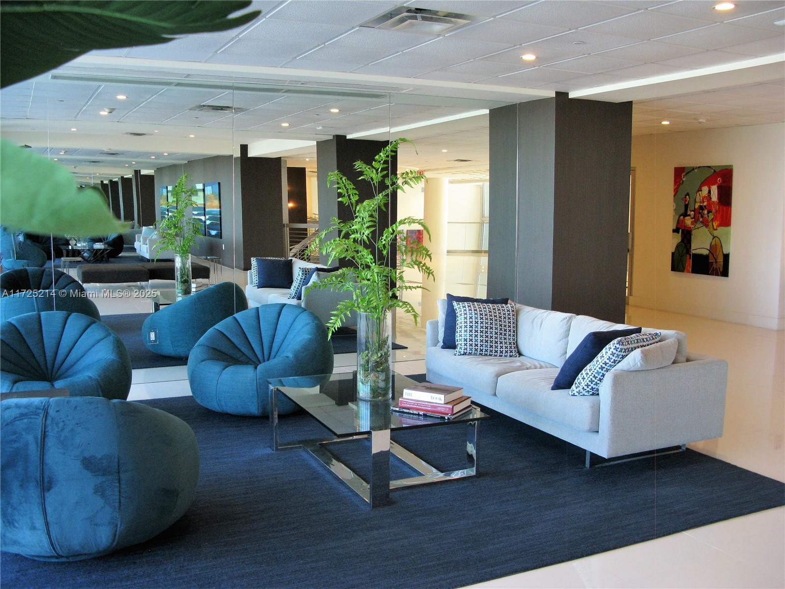 5701 Collins Avenue, Unit 1011 Miami Beach, FL 33140 - Photo 12 of 50 a living room with furniture and a potted plant