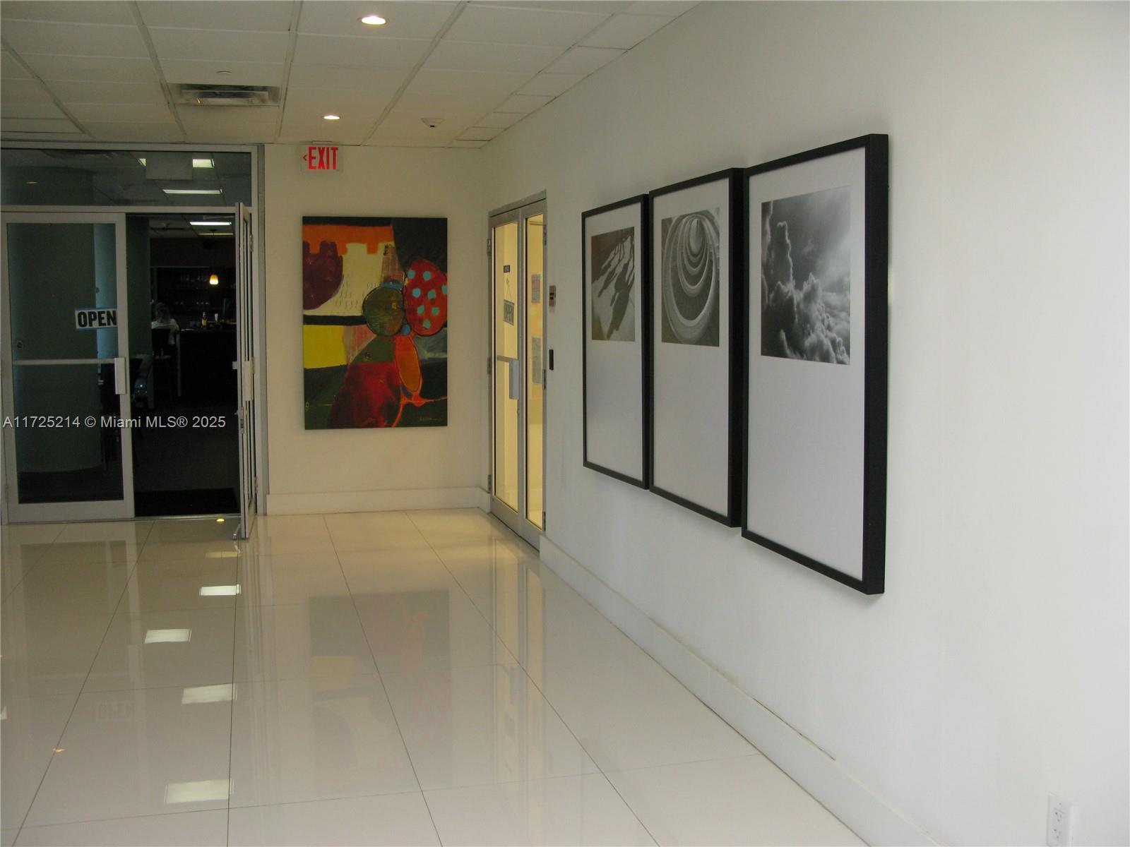 5701 Collins Avenue, Unit 1011 Miami Beach, FL 33140 - Photo 13 of 50 a view of a hallway with wooden shelves