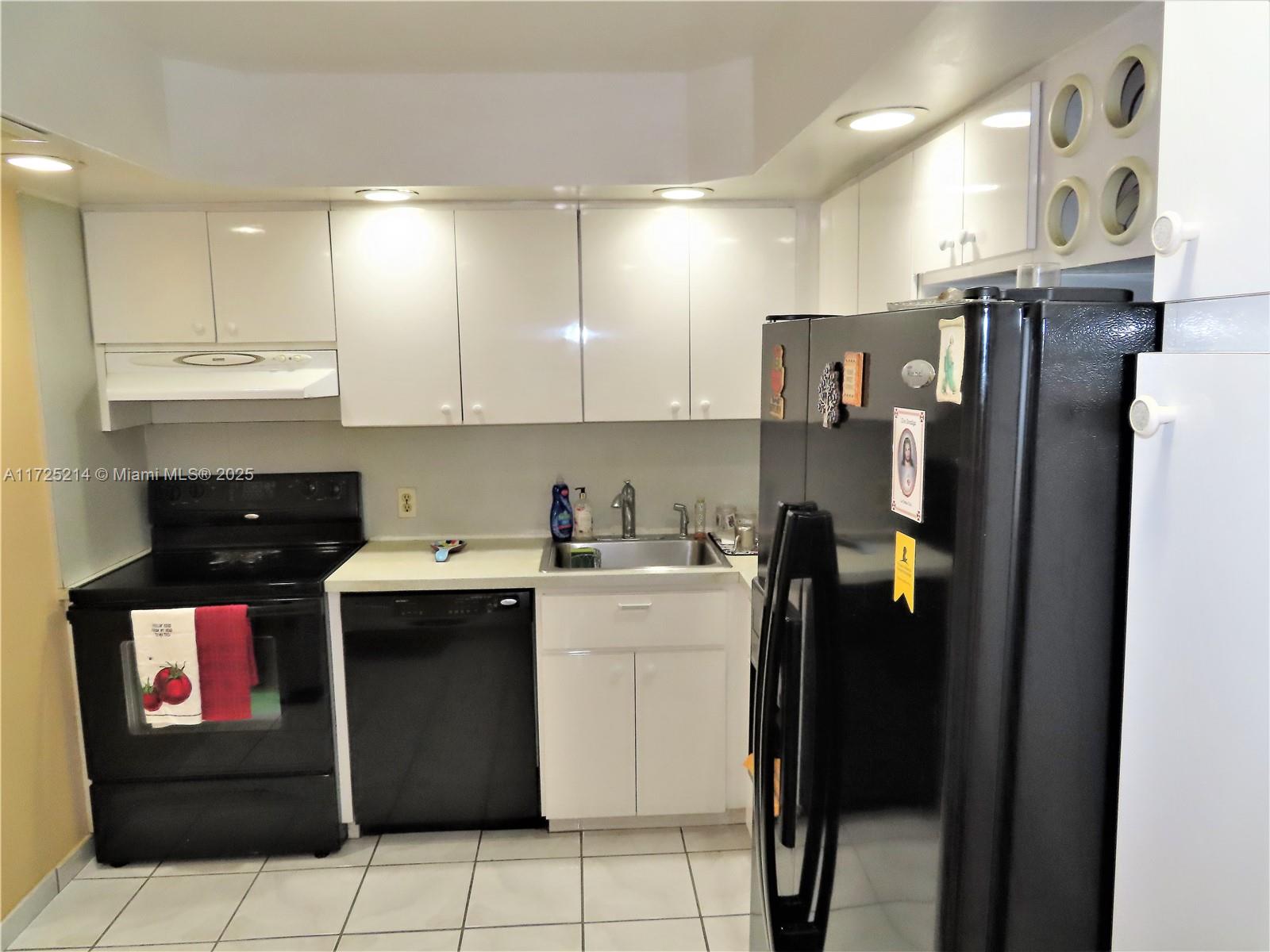 5701 Collins Avenue, Unit 1011 Miami Beach, FL 33140 - Photo 37 of 50 a kitchen with a sink a stove and refrigerator