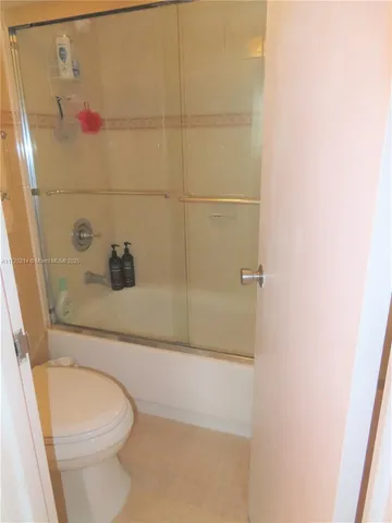 a hallway with view of a bathroom