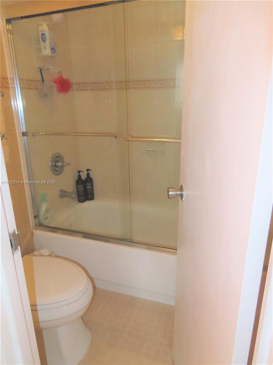 5701 Collins Avenue, Unit 1011 Miami Beach, FL 33140 - Photo 44 of 50 a bathroom with a toilet and shower