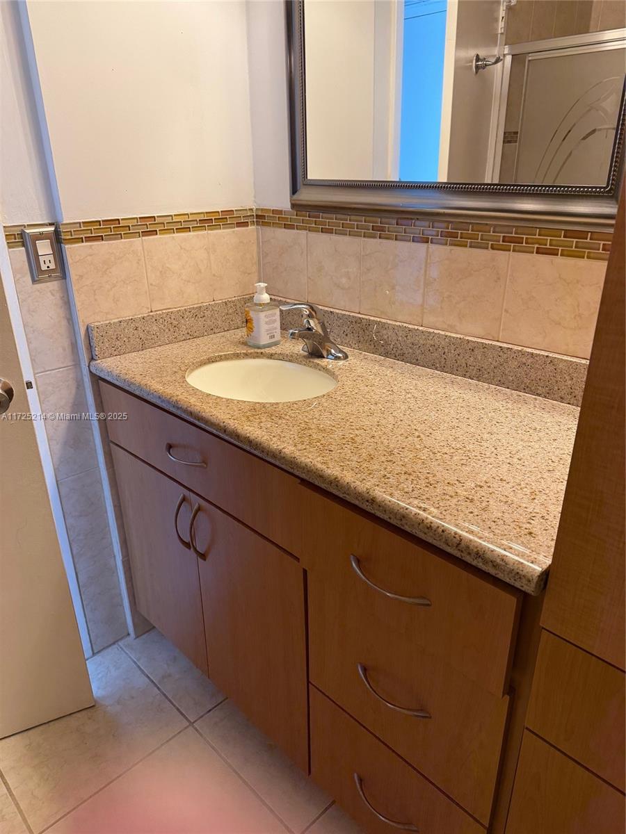 5701 Collins Avenue, Unit 1011 Miami Beach, FL 33140 - Photo 46 of 50 a sink with a vanity
