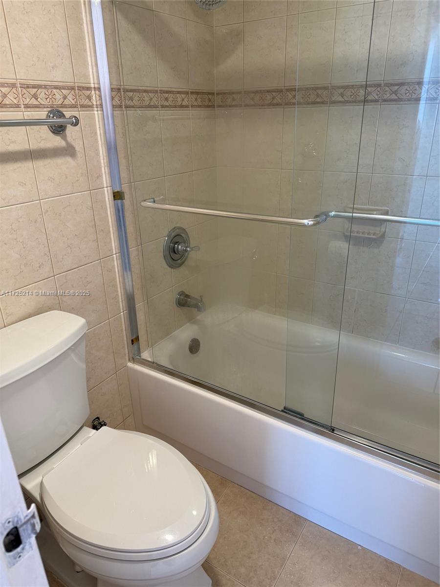 5701 Collins Avenue, Unit 1011 Miami Beach, FL 33140 - Photo 49 of 50 a bathroom with a toilet and a shower