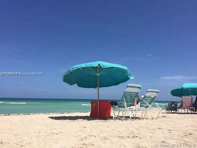 a table and chairs under an umbrella