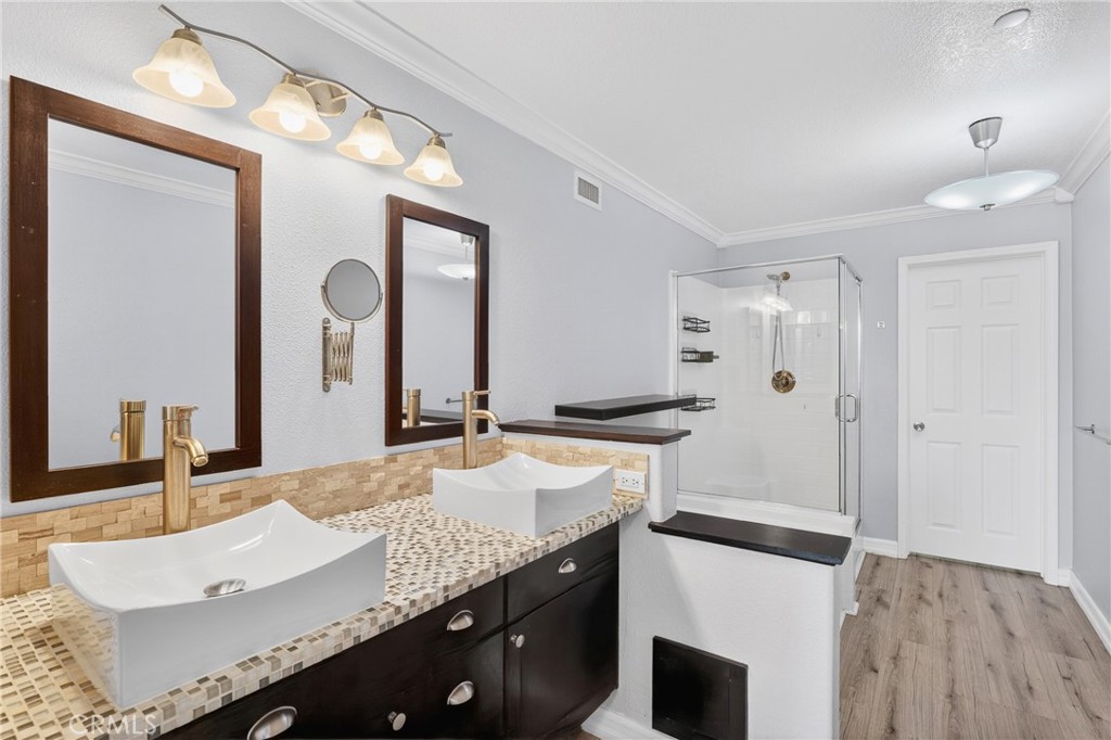 4 Palladium Lane Ladera Ranch, CA 92694 - Photo 17 of 38 a bathroom with a granite countertop sink a large mirror and a shower