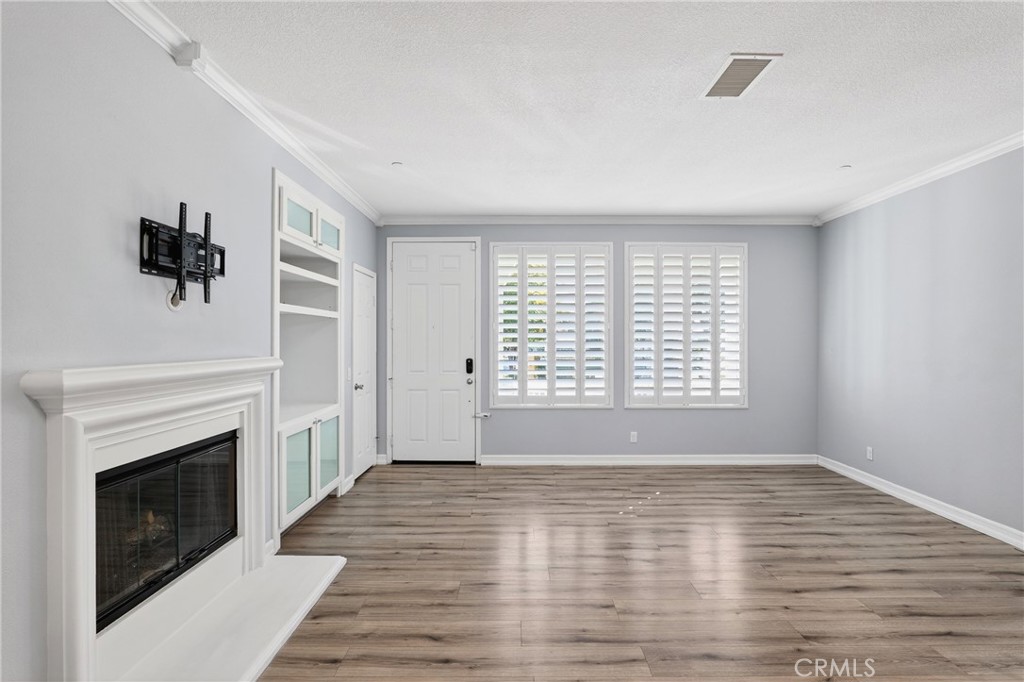 4 Palladium Lane Ladera Ranch, CA 92694 - Photo 4 of 38 a view of empty room with wooden floor and fireplace
