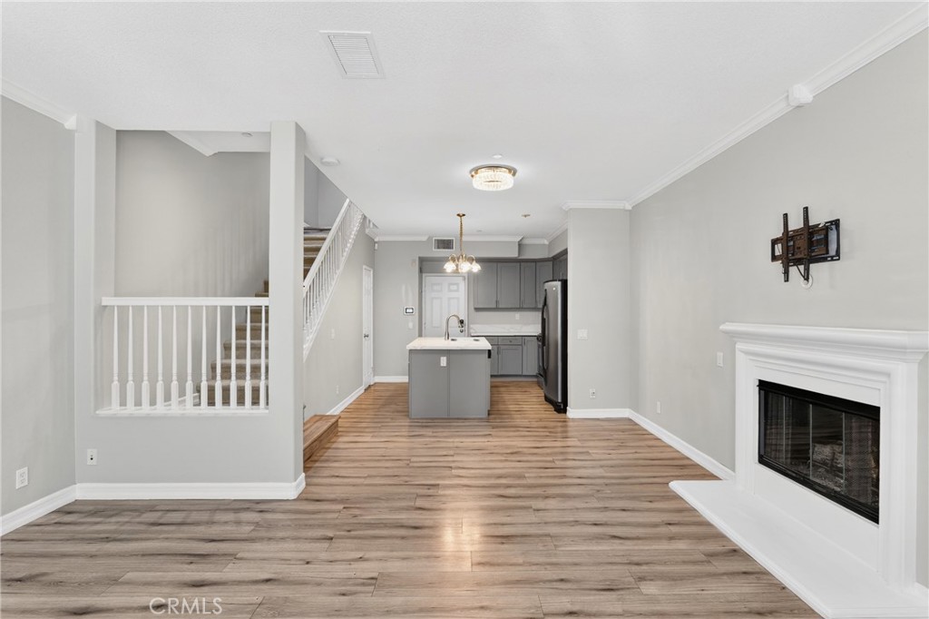 4 Palladium Lane Ladera Ranch, CA 92694 - Photo 5 of 38 a view of a hallway with wooden floor and a fireplace