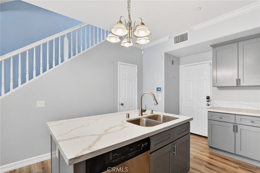 4 Palladium Lane Ladera Ranch, CA 92694 - Photo 9 of 38 a kitchen with a sink cabinets and wooden floor