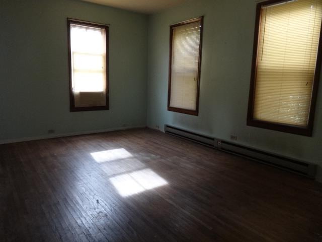 520 Villa Street Elgin, IL 60120 - Photo 5 of 16 an empty room with wooden floor and windows