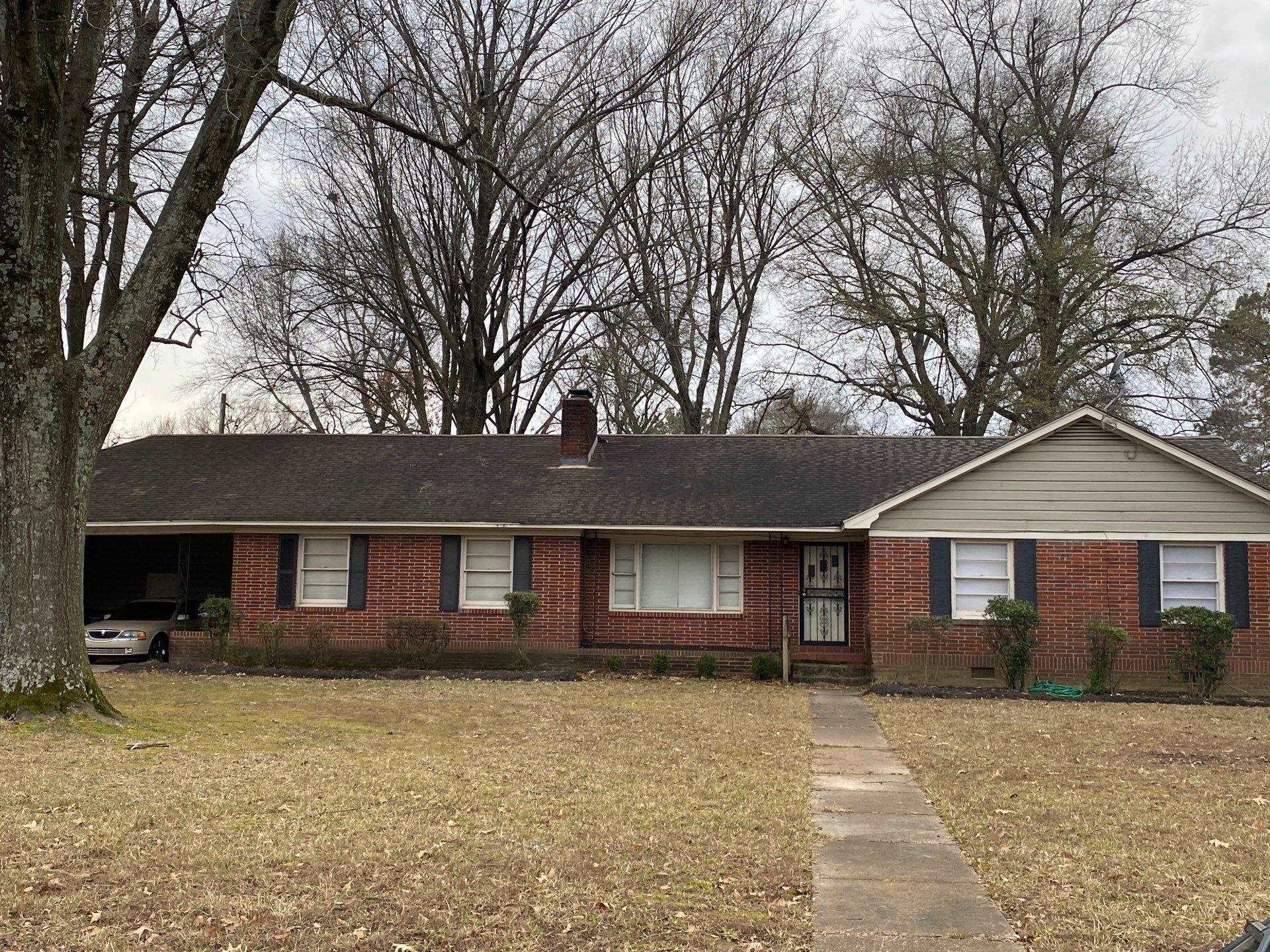 4377 Faronia Road Memphis, TN 38116 - Photo 1 of 1 Ranch-style home with a front yard, a chimney, brick siding, and a carport