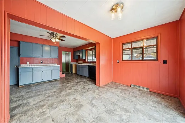 a view of kitchen with refrigerator and window