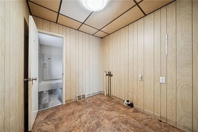 an empty room with fireplace and windows