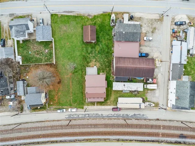 an aerial view of a house with a yard and garage