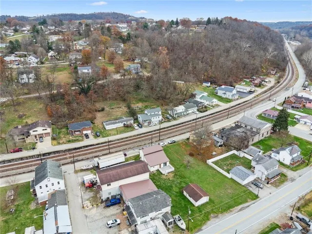 an aerial view of a house with a garden and trees