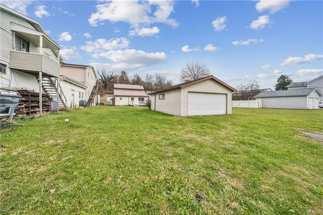 a view of a house with a yard and sitting area