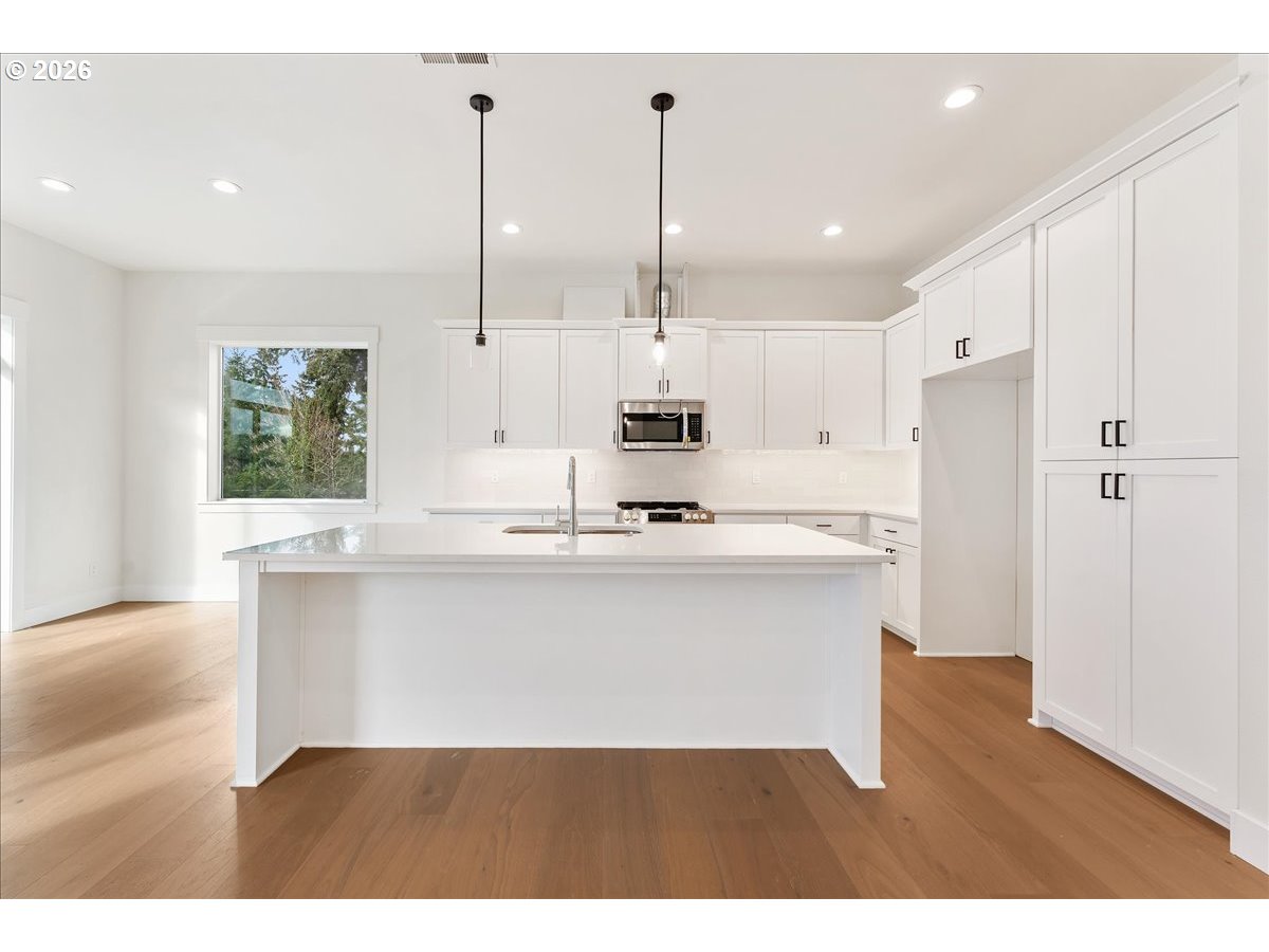 737 Southeast Forest Glen Road Estacada, OR 97023 - Photo 11 of 47 a kitchen with kitchen island a sink stainless steel appliances and cabinets